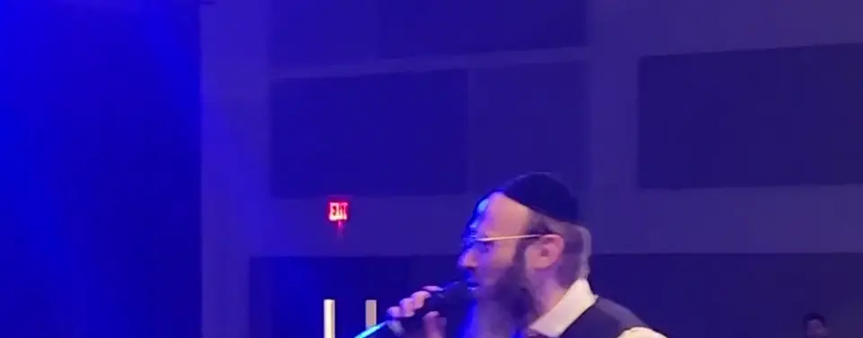 Rabbi Scheller teaching from the One Time stage